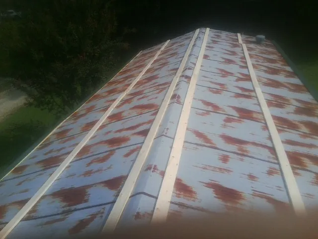 Rusted metal roof panels with new wood purlins before replacement — Storm Damage Roof Repair in Thurmont by Roofing Brothers
