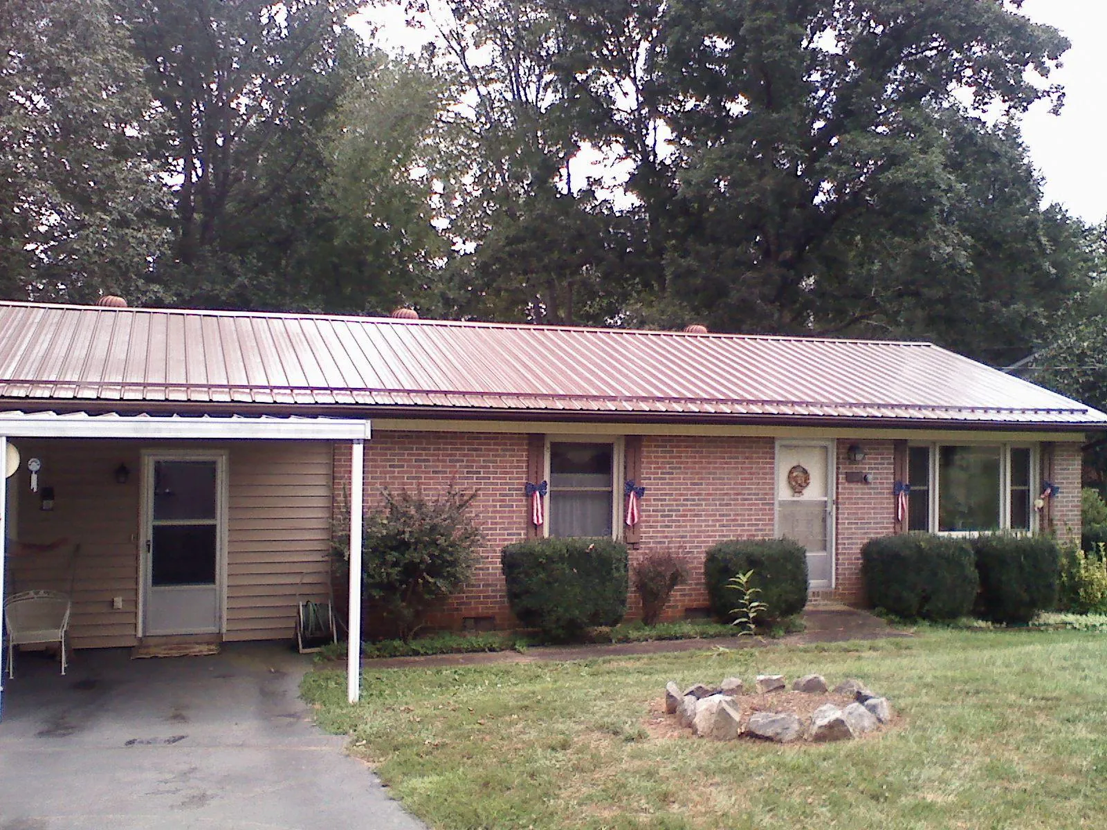 Bronze metal roof and carport on a brick ranch home — Roof Repair work by our crew in Thurmont