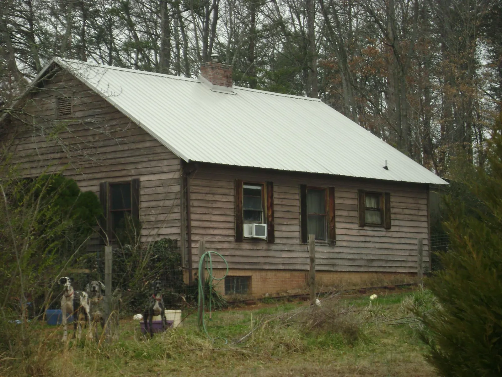 White metal roof on an old wood sided farmhouse, from a Metal Roof Installation job in Thurmont